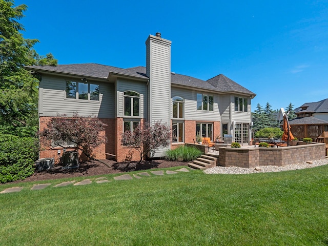 back of house with a lawn