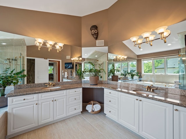 bathroom featuring plus walk in shower, vanity, and lofted ceiling