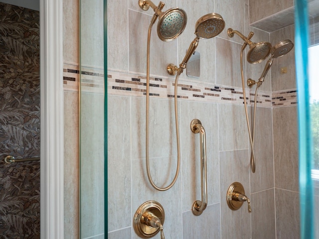 interior details featuring tiled shower