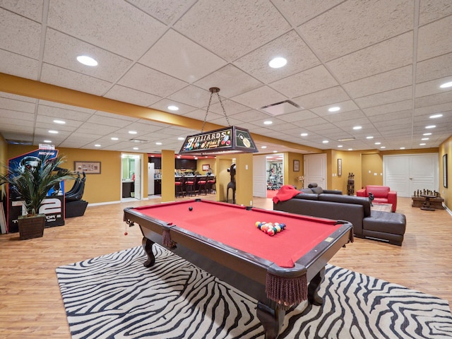 recreation room with a drop ceiling, wood-type flooring, and pool table