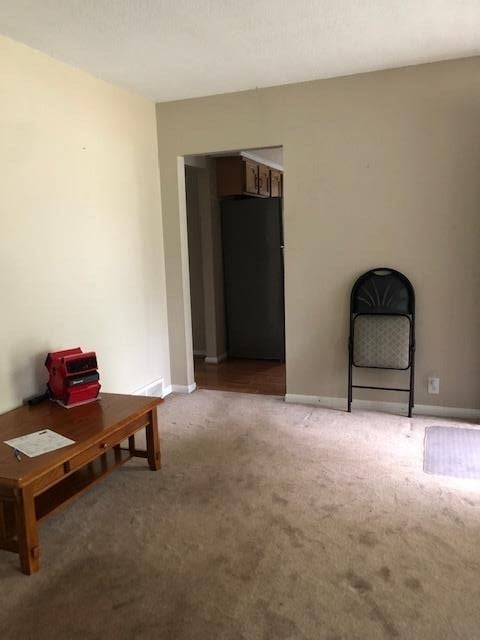 unfurnished room featuring carpet flooring