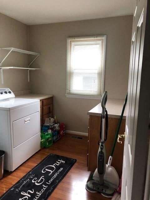 laundry area with washer / clothes dryer and hardwood / wood-style floors