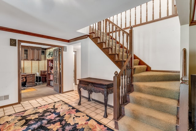 staircase featuring carpet floors and crown molding