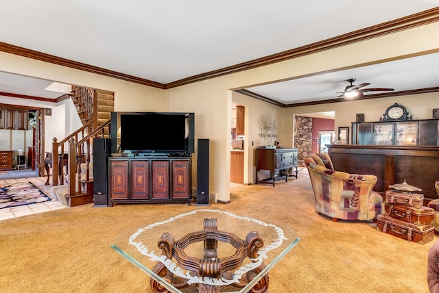 living room with carpet floors, ceiling fan, and ornamental molding