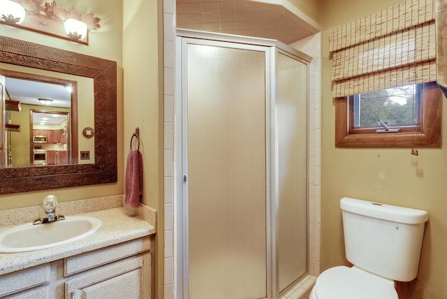 bathroom featuring vanity, toilet, and walk in shower