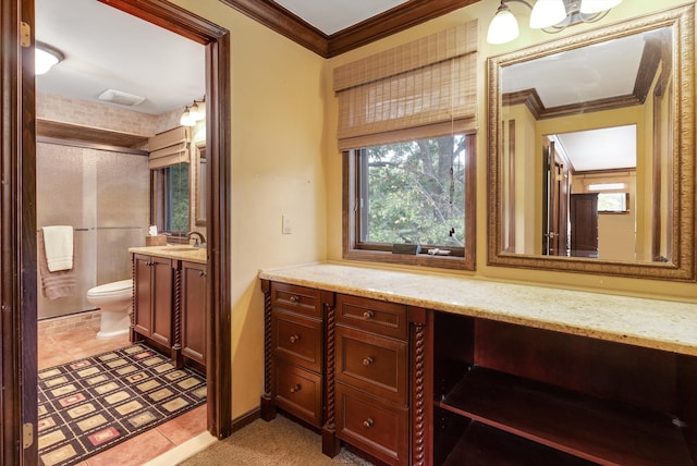 bathroom with tile patterned floors, vanity, toilet, and crown molding