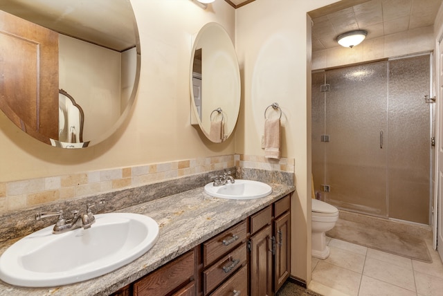 bathroom featuring tile patterned floors, vanity, toilet, and walk in shower