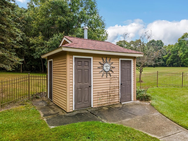 view of outbuilding with a lawn