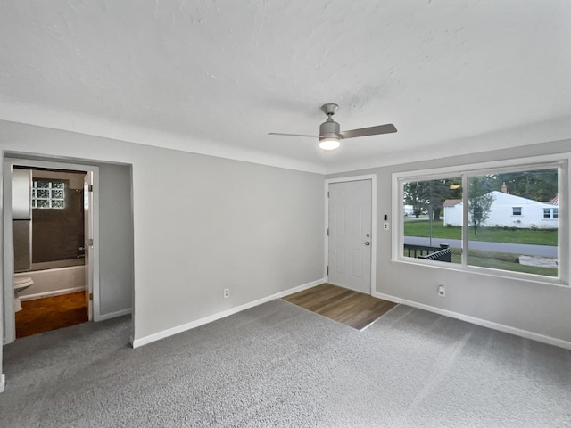 carpeted empty room featuring ceiling fan