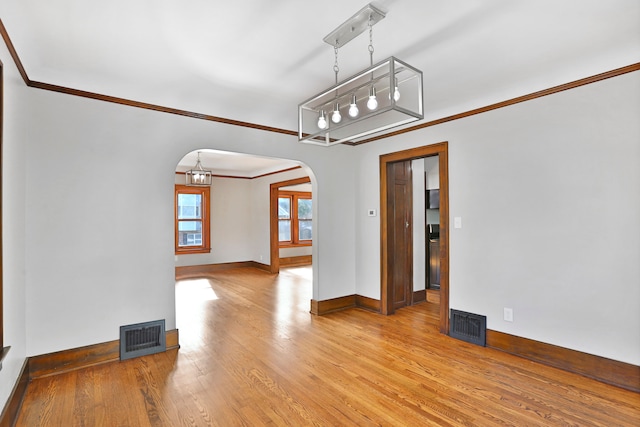 unfurnished room featuring light hardwood / wood-style floors and crown molding