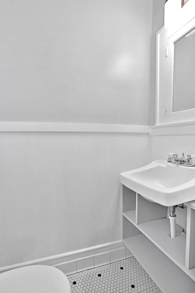 bathroom with tile patterned flooring, toilet, and sink