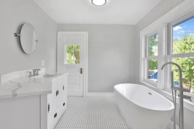 bathroom with a washtub and vanity