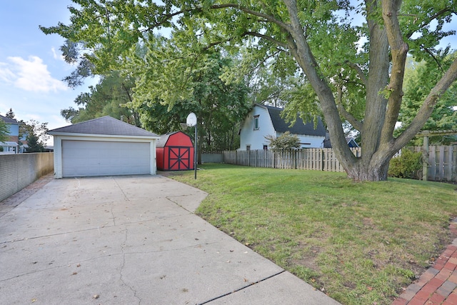 view of yard featuring a garage and a storage shed