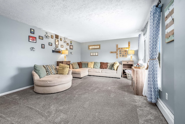 living room featuring a baseboard heating unit, carpet floors, and a textured ceiling