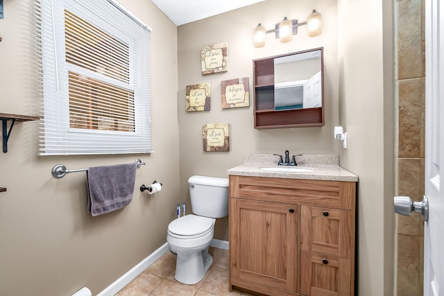 bathroom with vanity, tile patterned floors, and toilet