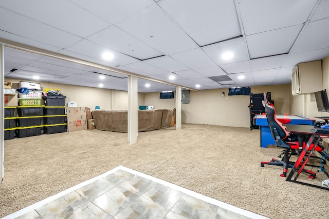 basement with carpet floors and a paneled ceiling