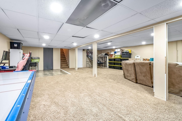 interior space with carpet floors and a paneled ceiling