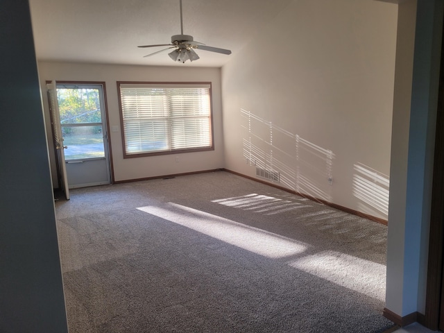 carpeted spare room featuring ceiling fan