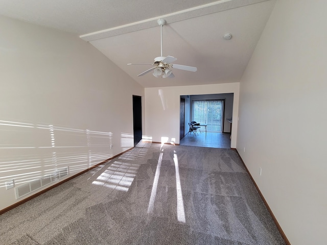 carpeted spare room with ceiling fan and lofted ceiling