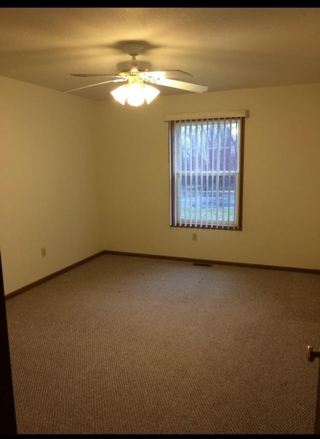 unfurnished room with ceiling fan and carpet floors