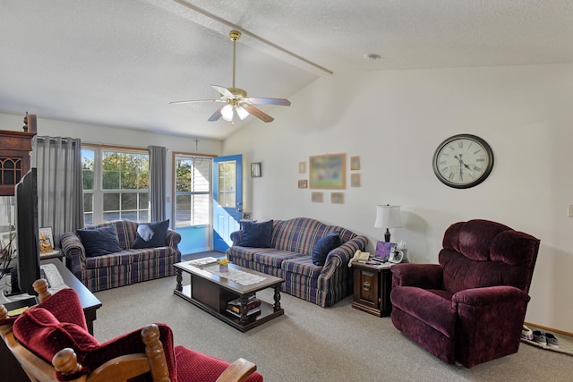 carpeted living room with a textured ceiling, ceiling fan, and vaulted ceiling