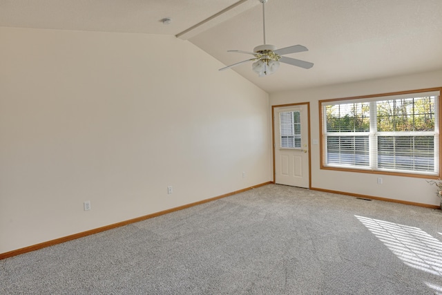 empty room with vaulted ceiling with beams, ceiling fan, and light colored carpet