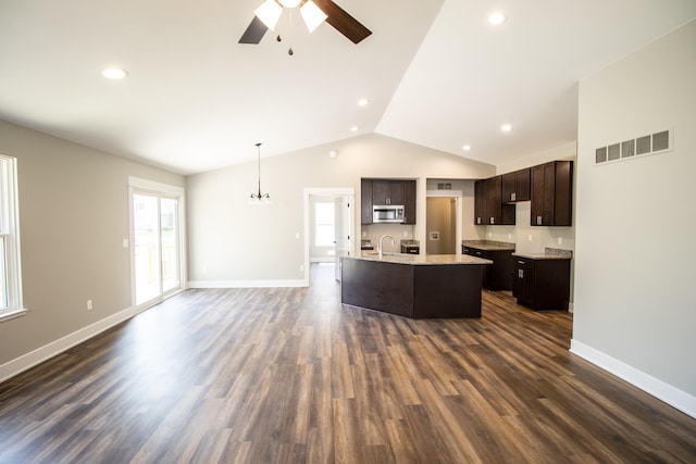 kitchen with dark brown cabinets, dark hardwood / wood-style floors, vaulted ceiling, and hanging light fixtures