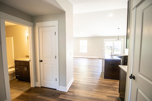 hallway with dark hardwood / wood-style floors and sink