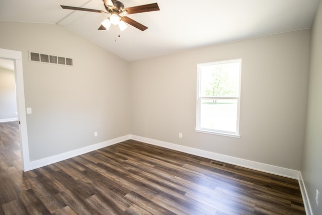 spare room featuring dark hardwood / wood-style flooring, vaulted ceiling, and ceiling fan