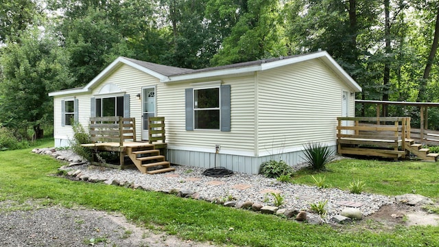 view of front of house with a front yard and a deck