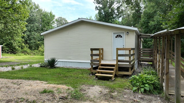 exterior space featuring a yard and a wooden deck