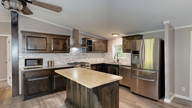 kitchen with a center island, wall chimney range hood, sink, light hardwood / wood-style flooring, and stainless steel appliances