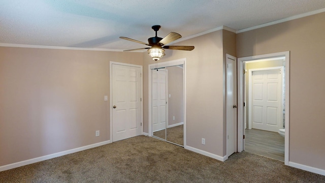 unfurnished bedroom featuring carpet flooring, ceiling fan, crown molding, lofted ceiling, and a textured ceiling