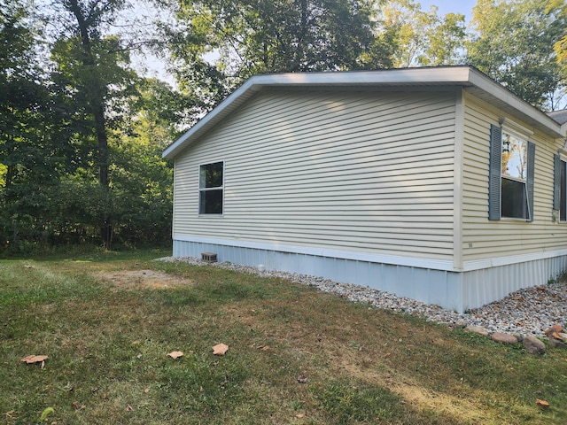 view of side of home with a yard