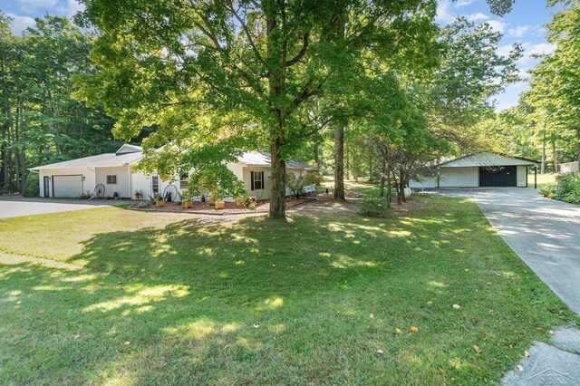 6610 E Arnold Lake Rd, Harrison, MI 48625 - obstructed view of property with a front yard and concrete driveway