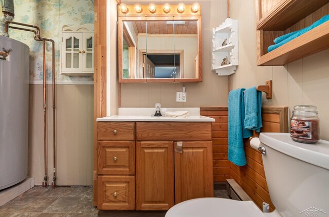 6610 E Arnold Lake Rd, Harrison, MI 48625 - bathroom featuring toilet, water heater, vanity, a wainscoted wall, and wooden walls