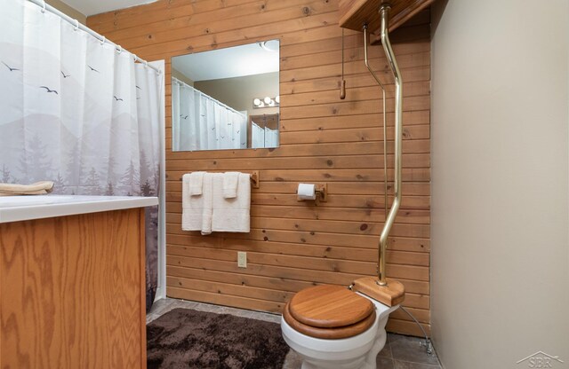 6610 E Arnold Lake Rd, Harrison, MI 48625 - full bath featuring wooden walls, vanity, and toilet