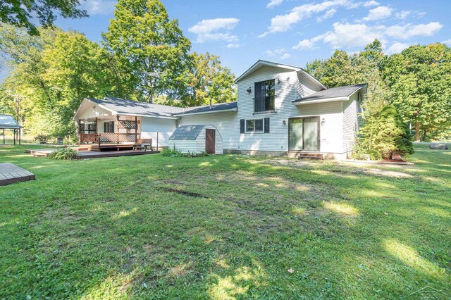 6610 E Arnold Lake Rd, Harrison, MI 48625 - back of house with a deck, a yard, and an outdoor hangout area