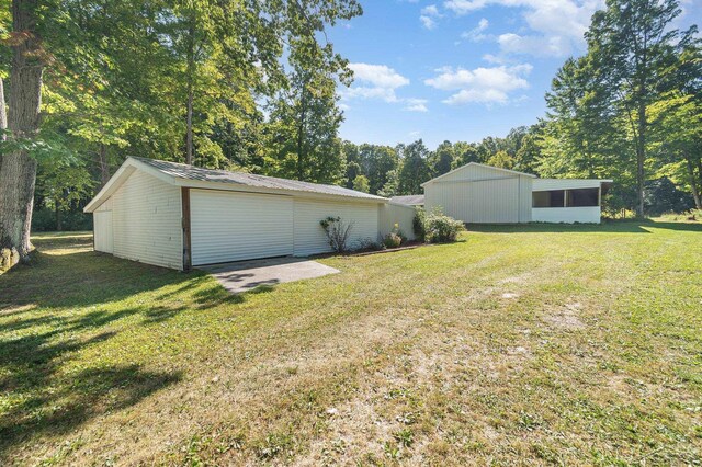 6610 E Arnold Lake Rd, Harrison, MI 48625 - view of green lawn featuring an outdoor structure