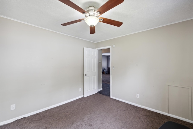 carpeted empty room featuring ceiling fan, a textured ceiling, and ornamental molding