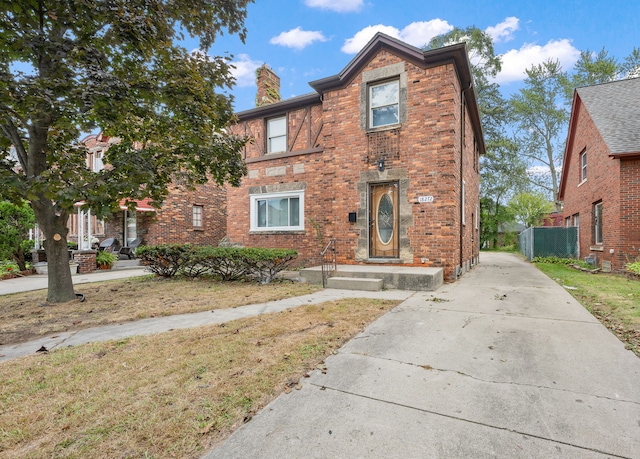 18272 Ohio St, Detroit, MI 48221 - view of front of home featuring a chimney, brick siding, and driveway