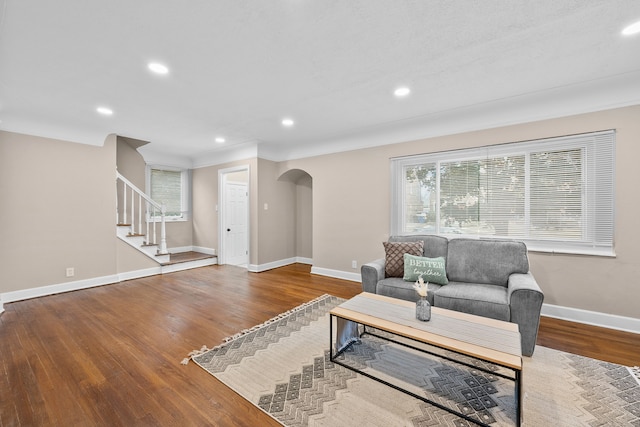 18272 Ohio St, Detroit, MI 48221 - living room with arched walkways, wood finished floors, stairs, recessed lighting, and baseboards