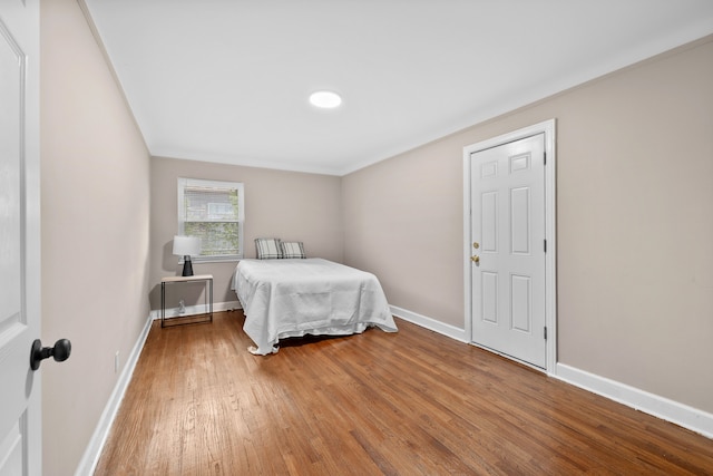 bedroom with hardwood / wood-style flooring