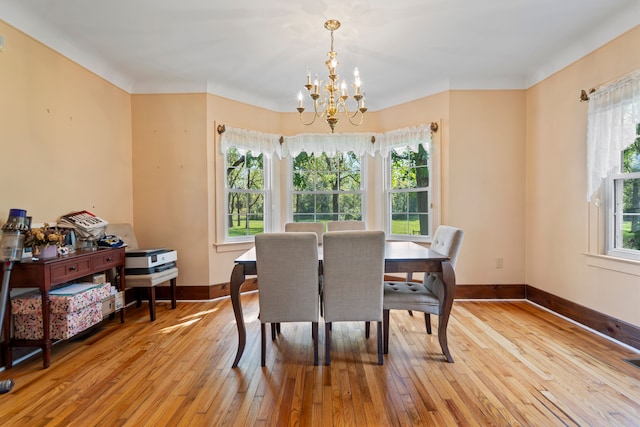 dining area featuring a notable chandelier and light hardwood / wood-style floors