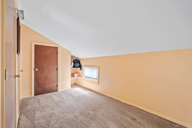 bonus room with carpet flooring and lofted ceiling