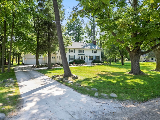 view of front of home with a front yard and a garage