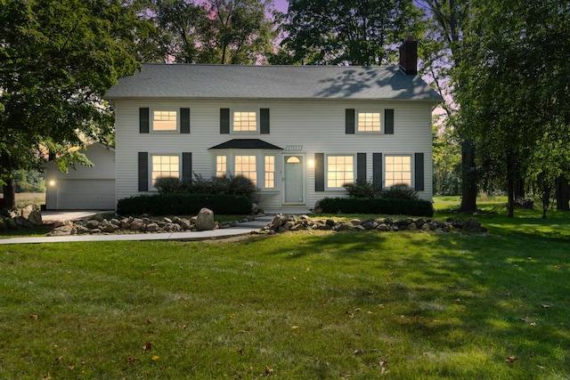 colonial house with a garage and a front yard