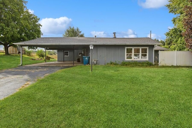 view of front facade with a front yard and a carport