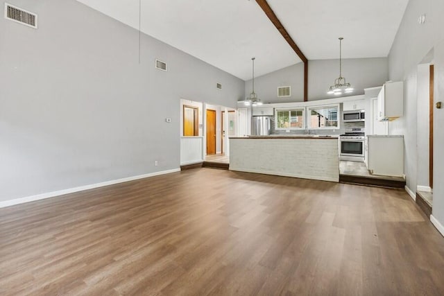 unfurnished living room with beamed ceiling, hardwood / wood-style floors, high vaulted ceiling, and an inviting chandelier