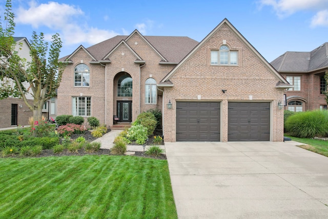 view of front of home featuring a garage and a front lawn